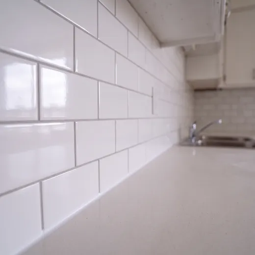 Close-up illustration of white subway tile with thin even grout lines
