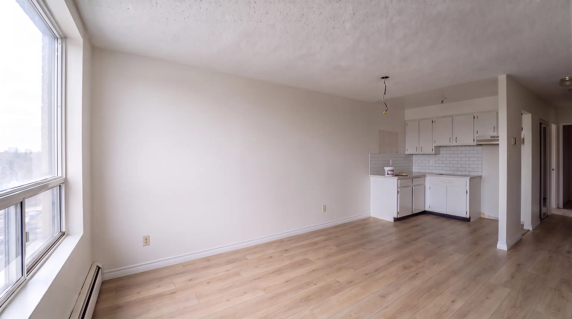 Illustration of the same unit with a new white tile backsplash in the kitchen